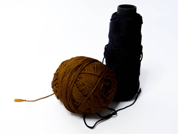 istock black and brown knitting yarn on a white background 1280804514