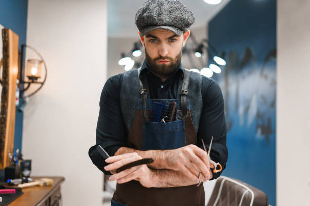 istock Serious barber with scissors and razor in hands 1280809044
