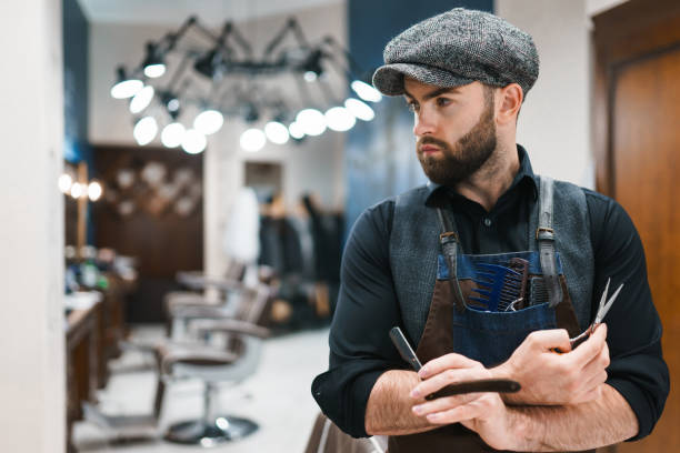 istock Serious barber with scissors and razor in hands 1280809047