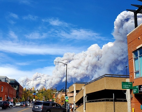 Boulder, CO, USA-October 17, 2020: Smoke from a large forest fire seen from downtown Boulder, CO looking north along 11th street.