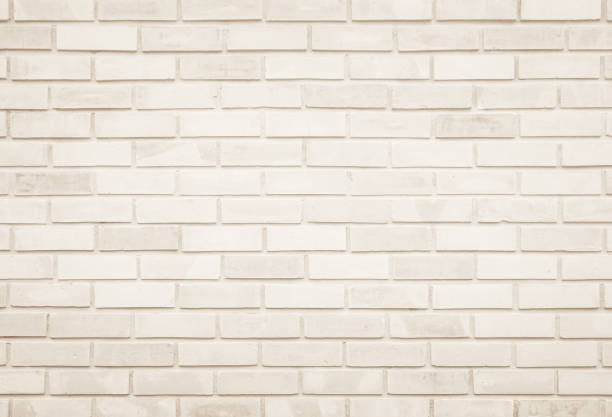 istock Empty Background of wide cream brick wall texture. Old brown brick wall concrete or stone pattern nature, wallpaper limestone abstract floor/Grid uneven interior rock. Home & office design backdrop. 1280811253