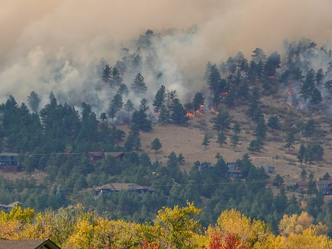 Forest fire near Boulder, Colorado. Burning the hillside, forest, and houses.