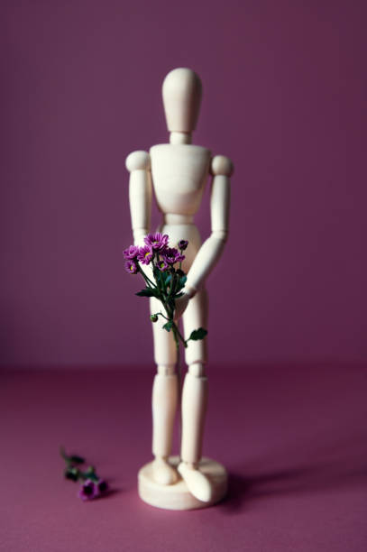 istock Wood man holding flowers 1280814571