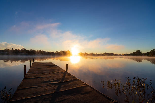 Fog rises off the water during the sunrise of an Autumn morning at Number One Pond in Sanford, Maine.