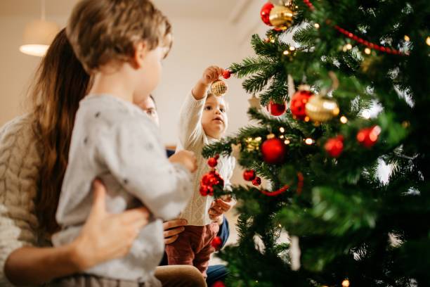 istock Family with kids decorating Christmas tree 1280821276