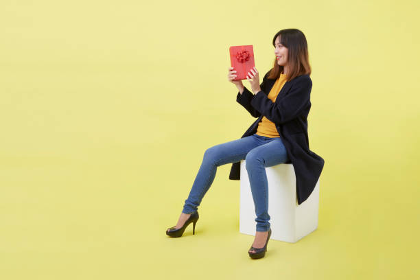 istock Young woman holding a gift box 1280824052