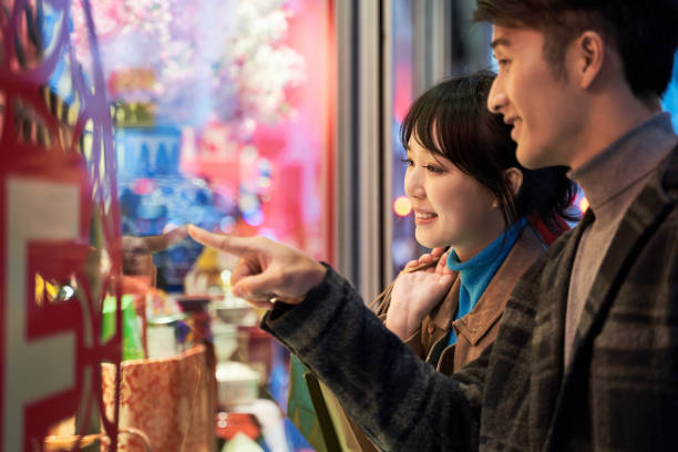 istock happy young asian couple looking into shop window 1280824733