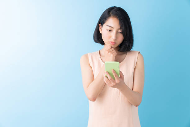 istock asian woman to see a smart phone,think, 1280824792