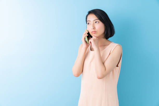 istock asian woman who talks on the telephone, think, 1280824804
