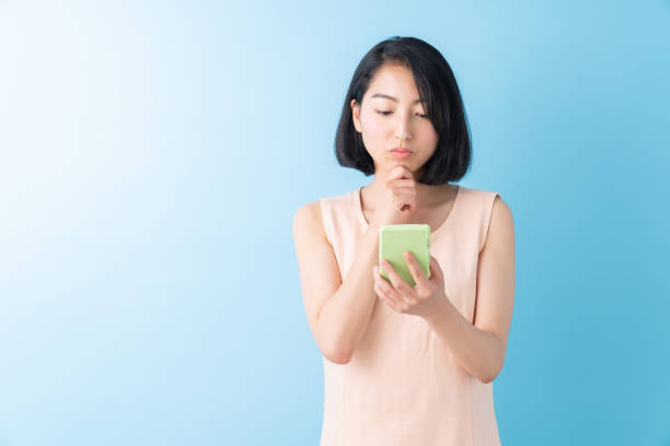 istock asian woman to see a smart phone,think, 1280824805