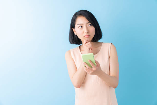 istock asian woman to see a smart phone,think, 1280824808