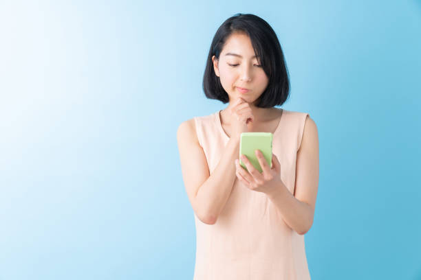 istock asian woman to see a smart phone,think, 1280824818