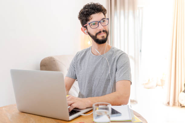 istock Hispanic man studying at home with headset 1280835804