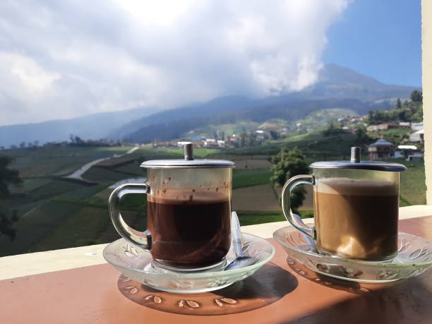 istock Cups of chocolate and coffee with mountain view. 1280836458