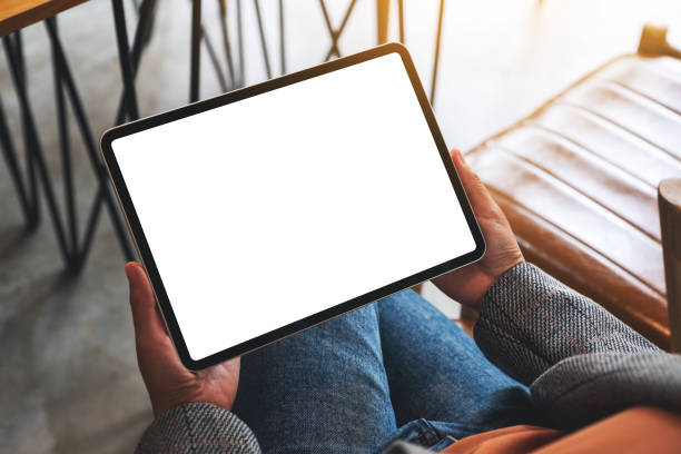 istock a woman holding digital tablet with blank white desktop screen 1280838847