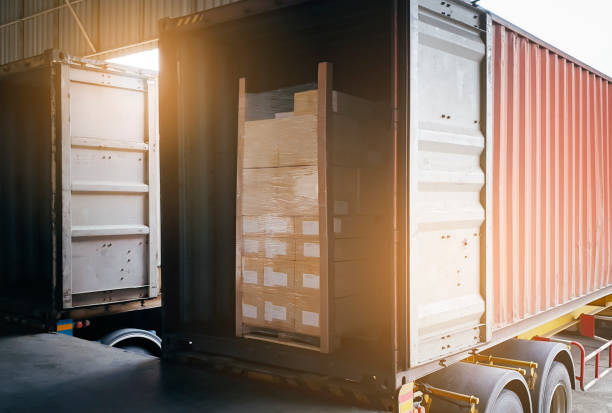 istock Cargo freight truck, Shipment boxes,  Logistics and transportation. Trailer truck docking to load cargo at the warehousing. 1280838921