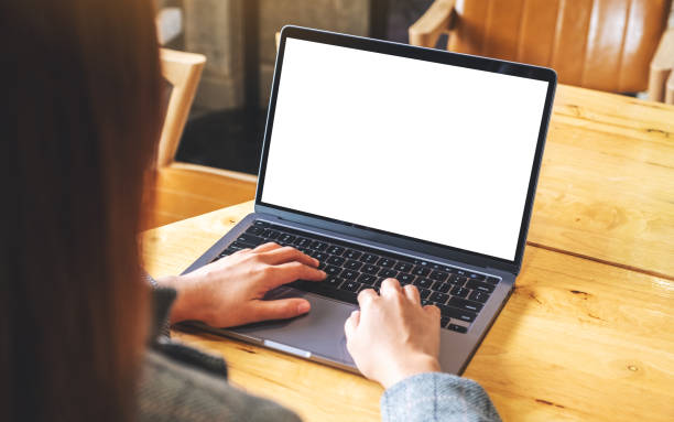 istock a businesswoman using and typing on laptop computer keyboard with blank white desktop screen on wooden table 1280840465