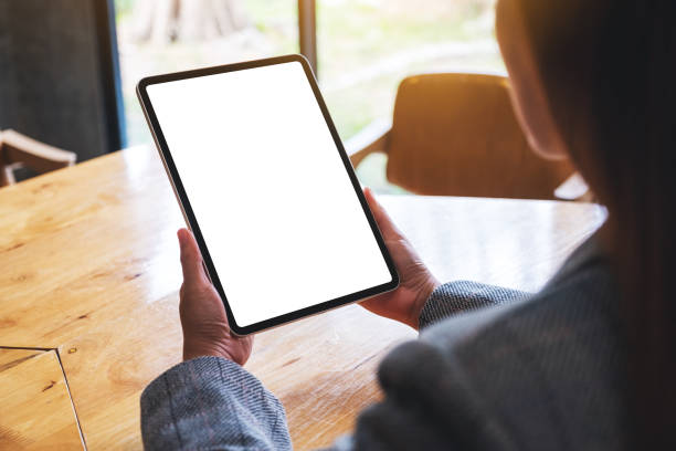 istock a woman holding digital tablet with blank white desktop screen 1280840466