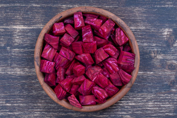 istock Fresh segments of a red beetroot, closeup. Purple beet slices background, top view 1280842700