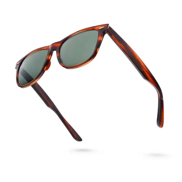 Photo of Vintage tortoise shell style plastic sunglasses isolated on white.