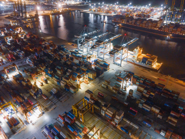 istock Logistics and transportation of Container Cargo ship and Cargo with working crane bridge in shipyard at sunrise, logistic import export and transport industry background 1280851147