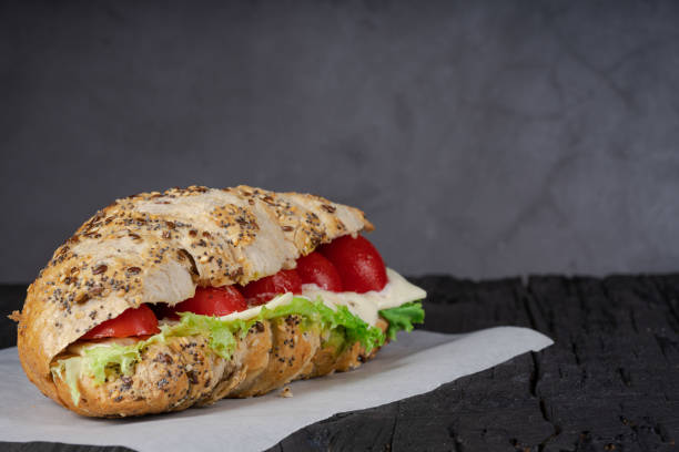 istock Ham sandwich on black wood 1280852240