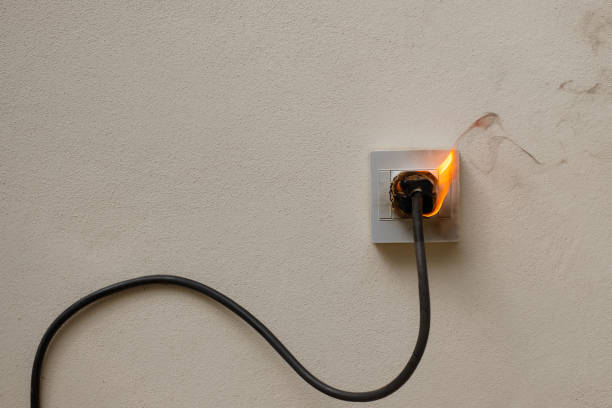 istock On fire electric wire plug Receptacle on the concrete wall background 1280853907