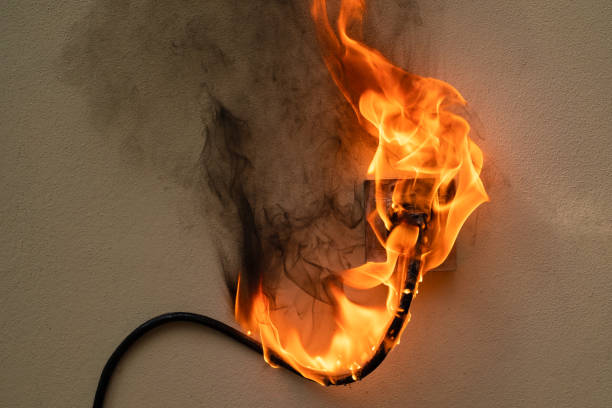 istock On fire electric wire plug Receptacle on the concrete wall background 1280853908