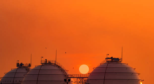 Industrial Gas Storage Tank On Orange Sunset Sky. Lng Or Liquefied Natural Gas Storage Tank. Photo taken in Chachoengsao, Thailand lng liquid natural gas stock pictures, royalty-free photos & images