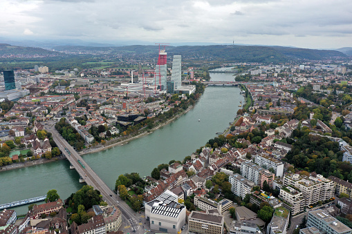 Basel City with its river Rhine and the new headquarters of Roche. The second tower under construction will be finished in 2020. The wide angle image was captured during autumn season.