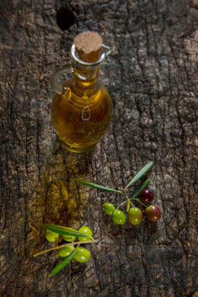 istock olive oil and fresh olives on the old table 1280859172