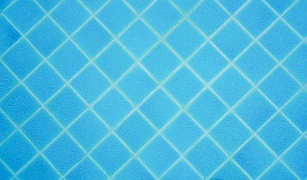 istock Top view of pool wall tiled with blue ceramic background 1280861593