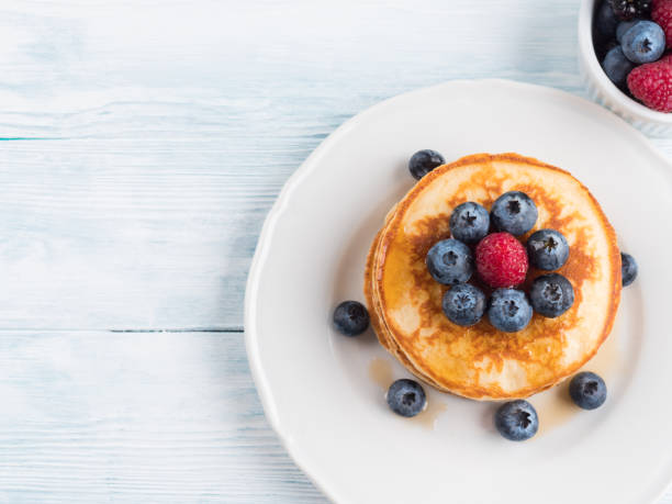 istock Stack of pancakes with blueberries and syrup 1280861972