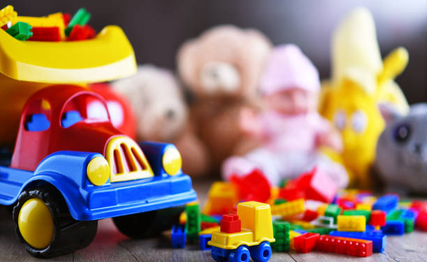 Colorful plastic and plush toys in a children's room Colorful plastic and plush toys in a children's room. dump truck photos stock pictures, royalty-free photos & images