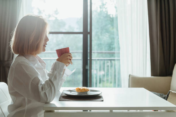 istock Asian woman drink coffee while take breakfast. 1280863137
