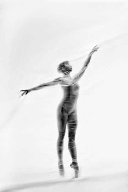 bailarina elegante bailando con nylon transparente - fantasy women blurred motion studio shot fotografías e imágenes de stock