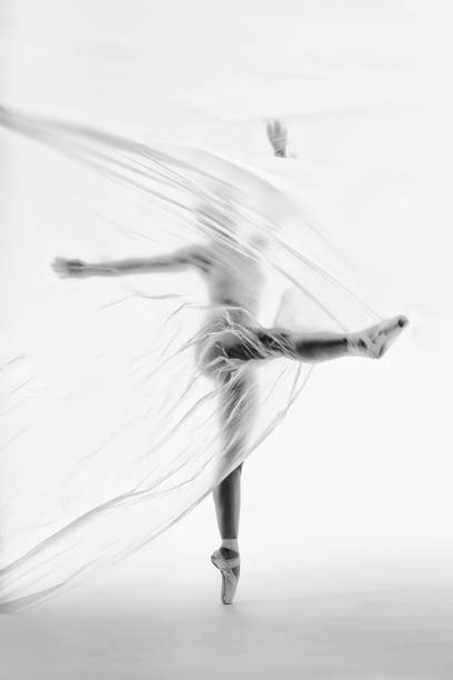 bailarina elegante bailando con nylon transparente - fantasy women blurred motion studio shot fotografías e imágenes de stock