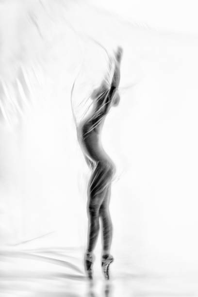 bailarina elegante bailando con nylon transparente - fantasy women blurred motion studio shot fotografías e imágenes de stock