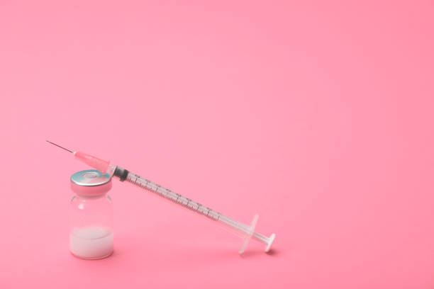 istock Syringe and amputes on fuchsia background.Vaccination. 1280866261
