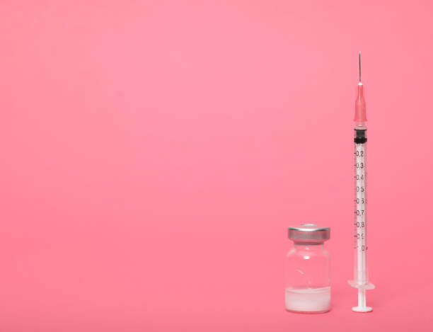 istock Syringe and amputes on fuchsia background.Vaccination. 1280866263