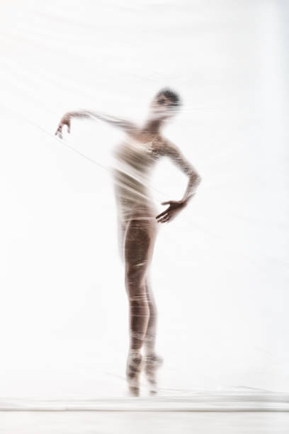 bailarina elegante bailando con nylon transparente - fantasy women blurred motion studio shot fotografías e imágenes de stock