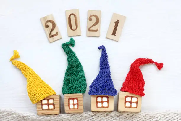 number 2021 and wooden houses in colorful hats
