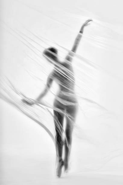 bailarina elegante bailando con nylon transparente - fantasy women blurred motion studio shot fotografías e imágenes de stock