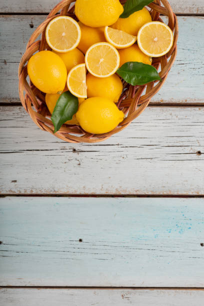 istock Lemons on light blue wooden background with copy space for text 1280869025