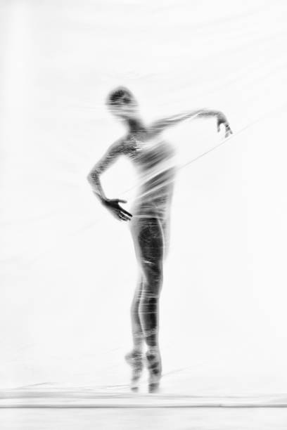 bailarina elegante bailando con nylon transparente - fantasy women blurred motion studio shot fotografías e imágenes de stock