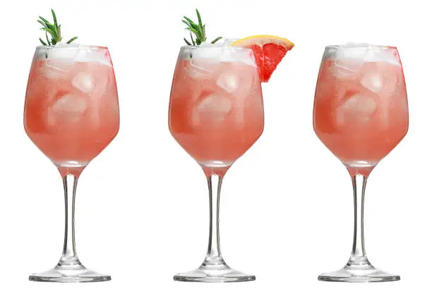 Alcoholic drink with tropical fruits and herbs and ice. Three alcoholic cocktails isolated on white.