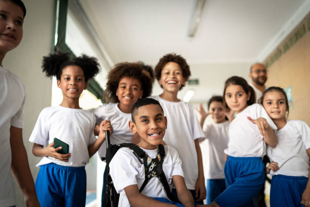 Portrait of a happy group of elementary students Portrait of a happy group of elementary students social inclusion photos stock pictures, royalty-free photos & images