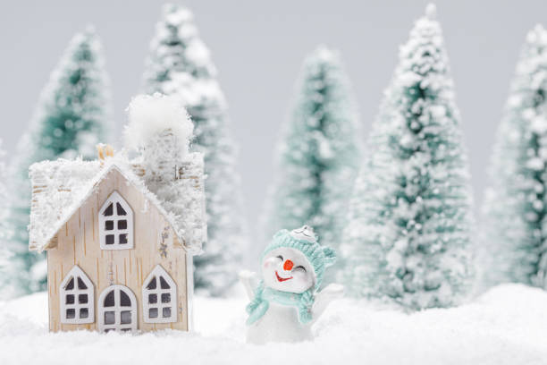 istock Snowman and house in winter 1280874903