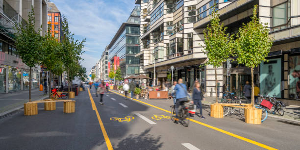 Fighting Climate Change with a City Pop-Up Bike Lane for a Carbon Neutral Future Pop-up bicycle lane in central Berlin with people biking, walking and relaxing. This is a trial concept for urban planning which improves the quality of life of people. berlin germany urban road panoramic germany stock pictures, royalty-free photos & images