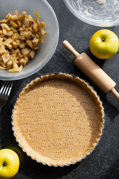 istock Raw shortbread dough for baking tart, apple pie and ingredients for home baking. 1280878884